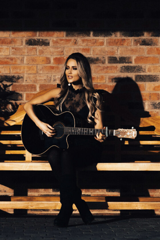 abi acoustic singer on bench